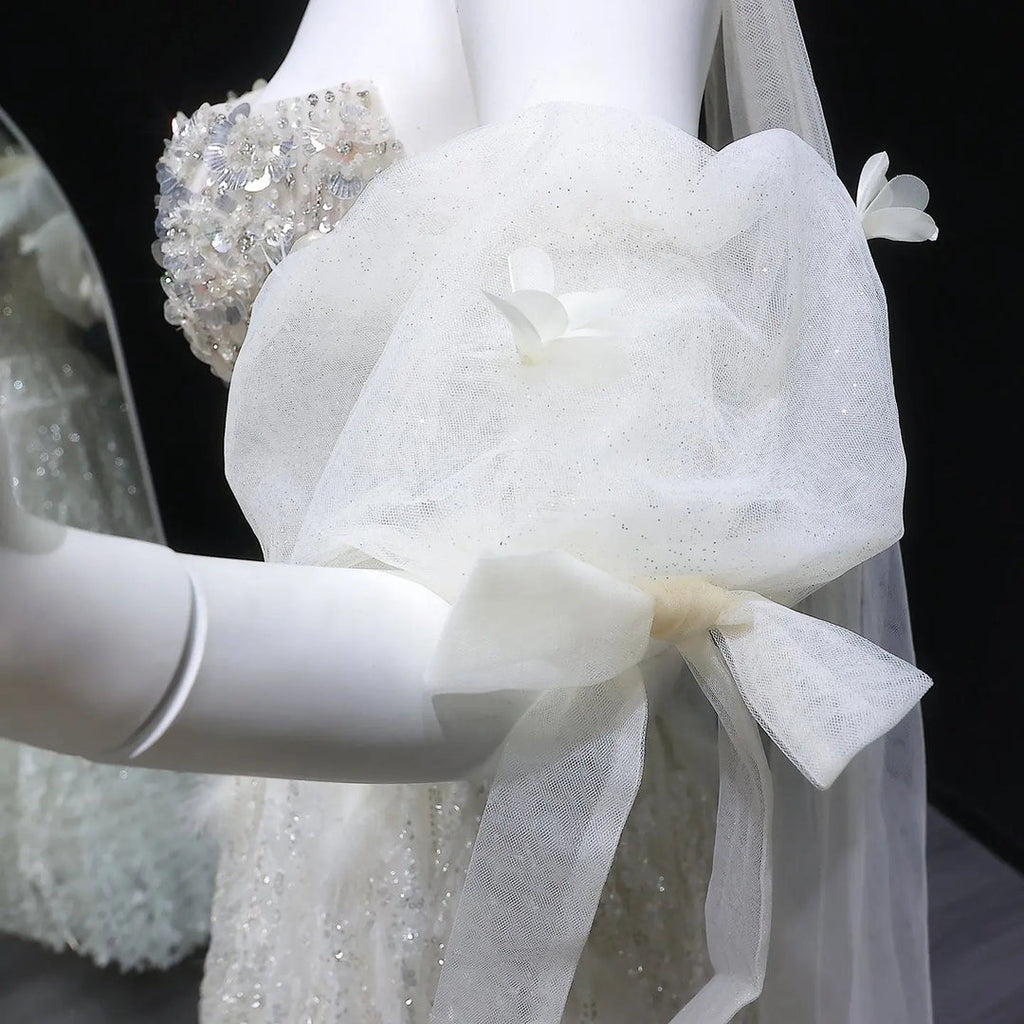 Elegant Beige Embellished Evening Gown with Petal Detailing SB011