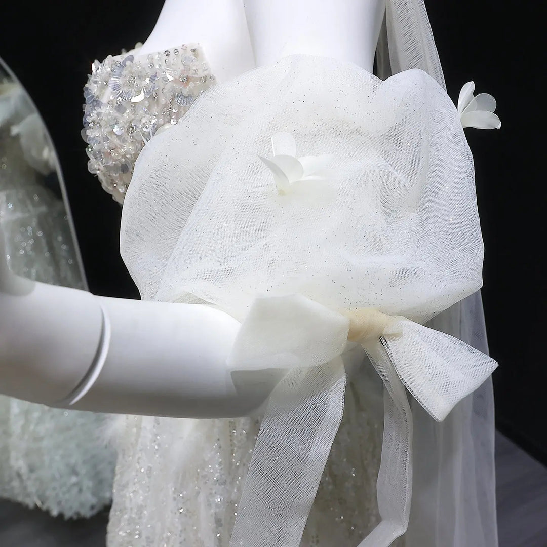Elegant Beige Embellished Evening Gown with Petal Detailing SB011